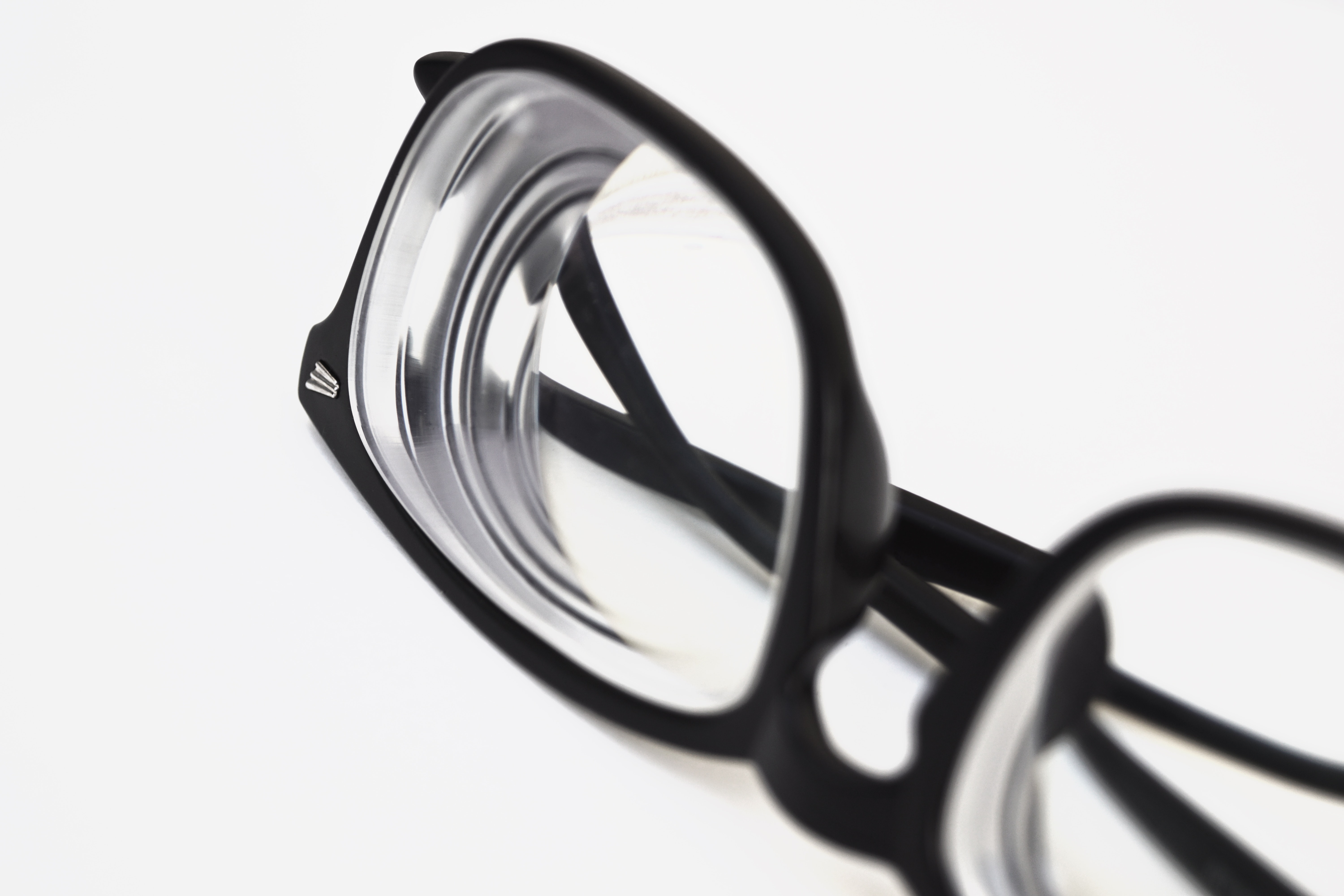 Pair of black glasses with extremely thick lenses